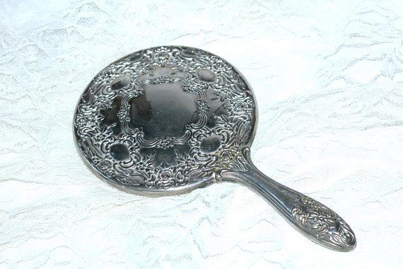 ornate vintage silver hand mirror
